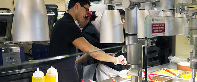 Joseph Abreu, student food server prepares Mexican cuisine at the newly expanded Picantes station at the Union Commons